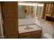 Bathroom featuring a vanity with a sink, a mirror and wood cabinets for storage at 5602 W Heatherbrae Dr, Phoenix, AZ 85031