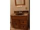 Bathroom vanity features a marble countertop and a wooden cabinet at 5602 W Heatherbrae Dr, Phoenix, AZ 85031