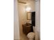 Image of a half bath featuring a dark wood vanity at 5602 W Heatherbrae Dr, Phoenix, AZ 85031