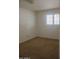 Simple bedroom offers a clean look with natural light with neutral paint and carpeting at 5602 W Heatherbrae Dr, Phoenix, AZ 85031