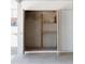 Open closet with a brick back, wooden shelves, and a fire extinguisher for safety at 5602 W Heatherbrae Dr, Phoenix, AZ 85031