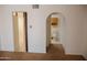 Hallway view to a bathroom with a vintage wall cabinet and to a room with tiled flooring at 5602 W Heatherbrae Dr, Phoenix, AZ 85031