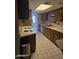 The kitchen features a tile floor, light countertops and wooden cabinets at 5602 W Heatherbrae Dr, Phoenix, AZ 85031