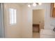 Bright kitchen featuring a window, ceiling fan and doorway leading to a utility area at 5602 W Heatherbrae Dr, Phoenix, AZ 85031