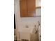 A quaint laundry room with sink, cabinet, and washer at 5602 W Heatherbrae Dr, Phoenix, AZ 85031