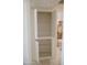 Linen closet with adjustable shelving next to bathroom, providing additional storage space at 5602 W Heatherbrae Dr, Phoenix, AZ 85031