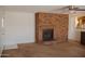 A spacious living room featuring a brick fireplace and ceiling fan at 5602 W Heatherbrae Dr, Phoenix, AZ 85031