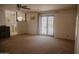 A living room with access to the backyard through glass doors and a ceiling fan at 5602 W Heatherbrae Dr, Phoenix, AZ 85031