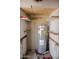 Storage room featuring a modern Rheem water heater with open shelving at 5602 W Heatherbrae Dr, Phoenix, AZ 85031