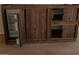 Wet bar with refrigerator and sliding doors for storage at 5602 W Heatherbrae Dr, Phoenix, AZ 85031