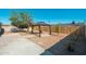 Backyard featuring a charming gazebo with tan curtains and a concrete patio at 5951 W Granada Rd, Phoenix, AZ 85035