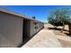 Exterior view of a patio that leads to a wooden fence and greenery on a bright sunny day at 5951 W Granada Rd, Phoenix, AZ 85035