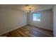A bedroom featuring a window, wood flooring, and modern lighting at 5951 W Granada Rd, Phoenix, AZ 85035
