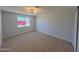 A bedroom with carpet flooring and a window at 5951 W Granada Rd, Phoenix, AZ 85035