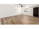 A minimalistic bedroom featuring wood floors, a ceiling fan, and a light and airy atmosphere at 5951 W Granada Rd, Phoenix, AZ 85035