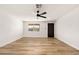 A minimalistic bedroom featuring wood floors, a ceiling fan, and a light and airy atmosphere at 5951 W Granada Rd, Phoenix, AZ 85035
