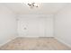 Neutral bedroom with wall-to-wall carpeting, a modern ceiling light, closet, and door at 5951 W Granada Rd, Phoenix, AZ 85035