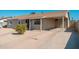 View of the side and front of this single-story home featuring a carport at 5951 W Granada Rd, Phoenix, AZ 85035