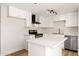 Bright kitchen with white cabinets, stainless steel appliances, and a center island at 5951 W Granada Rd, Phoenix, AZ 85035