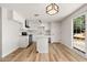 Modern kitchen with white cabinets, stainless steel appliances, and a center island at 5951 W Granada Rd, Phoenix, AZ 85035