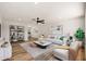 Bright living room with hardwood floors, modern furnishings, and a ceiling fan at 5951 W Granada Rd, Phoenix, AZ 85035