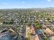 A sprawling residential area from an aerial perspective, featuring an organized layout, lush greenery, and distant mountains at 6805 S 14Th St, Phoenix, AZ 85042