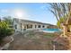 Spacious backyard featuring a refreshing in-ground swimming pool, covered patio, and low-maintenance landscaping at 6805 S 14Th St, Phoenix, AZ 85042