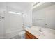 This bright bathroom features a tub and shower combo, toilet, and sink with vanity at 6805 S 14Th St, Phoenix, AZ 85042