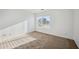 Bright, sunlit bedroom with plush carpet, a large window, and clean white walls, creating a calming atmosphere at 6805 S 14Th St, Phoenix, AZ 85042