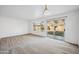 Empty living room with a sliding glass door providing access to the backyard at 6805 S 14Th St, Phoenix, AZ 85042