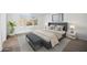 Stylish bedroom with a gray upholstered bed, bench, modern art and coordinated decor creating a serene space at 6805 S 14Th St, Phoenix, AZ 85042