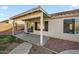 Covered patio extends from the home, offering an outdoor seating area and access to the backyard at 6805 S 14Th St, Phoenix, AZ 85042