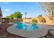 Backyard swimming pool surrounded by desert landscaping, block fencing, and a basketball hoop at 6805 S 14Th St, Phoenix, AZ 85042