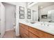 Well-lit bathroom with double sinks, light wood cabinets, and neutral tile flooring at 705 W Queen Creek Rd # 2062, Chandler, AZ 85248