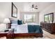 Cozy bedroom with a traditional-style wooden dresser, a ceiling fan, and a window with a view at 705 W Queen Creek Rd # 2062, Chandler, AZ 85248