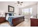 Inviting bedroom with a wooden sleigh bed, soft lighting, and a large window with blinds at 705 W Queen Creek Rd # 2062, Chandler, AZ 85248