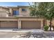 Attractive townhome featuring a two-car attached garage and well-maintained landscaping at 705 W Queen Creek Rd # 2062, Chandler, AZ 85248