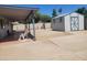 Backyard featuring a covered patio with seating and a shed at 761 W Gail Dr, Chandler, AZ 85225