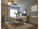Dining room featuring modern decor, a ceiling fan, and a large window for natural light at 761 W Gail Dr, Chandler, AZ 85225