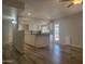Open living area with wood floors, white kitchen, and ample natural light from the back door and window at 761 W Gail Dr, Chandler, AZ 85225