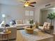 Bright living room featuring a ceiling fan, large windows, and stylish furniture at 761 W Gail Dr, Chandler, AZ 85225
