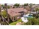 Back of beige home with a terracotta roof, covered patio, pristine pool, desert landscaping, and palm trees at 786 E Coconino Dr, Chandler, AZ 85249