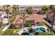 Beige home with a terracotta roof, covered patio, sparkling pool, desert landscaping, and mature trees at 786 E Coconino Dr, Chandler, AZ 85249