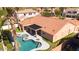 Beige home with a terracotta roof, covered patio, artificial grass, lovely pool, and desert landscaping at 786 E Coconino Dr, Chandler, AZ 85249