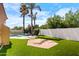 Lush backyard with artificial turf and a brick patio featuring palm trees at 786 E Coconino Dr, Chandler, AZ 85249