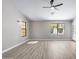 Bedroom featuring modern ceiling fan, two windows, stylish light wood flooring and neutral color palette at 786 E Coconino Dr, Chandler, AZ 85249