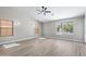 Bright bedroom featuring modern ceiling fan, multiple windows, and stylish light wood flooring at 786 E Coconino Dr, Chandler, AZ 85249