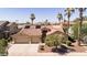 Inviting beige home with terracotta roof, two-car garage, desert landscaping, and solar panels at 786 E Coconino Dr, Chandler, AZ 85249