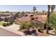 Beige home with a terracotta roof, two-car garage, desert landscaping, solar panels, and palm trees at 786 E Coconino Dr, Chandler, AZ 85249