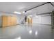 Spacious three-car garage with epoxy floors and ample storage and overhead lighting at 786 E Coconino Dr, Chandler, AZ 85249